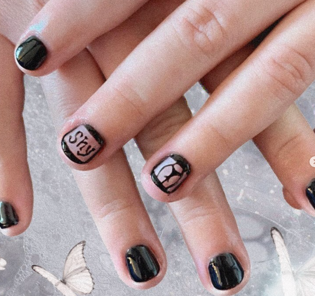 Nailart i sort med en bagdel og teksten 'shy'